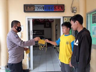 Selalu Gunakan Masker, Aiptu Carlan Bagikan Masker di Desa Binaan Polsek Pameungpeuk